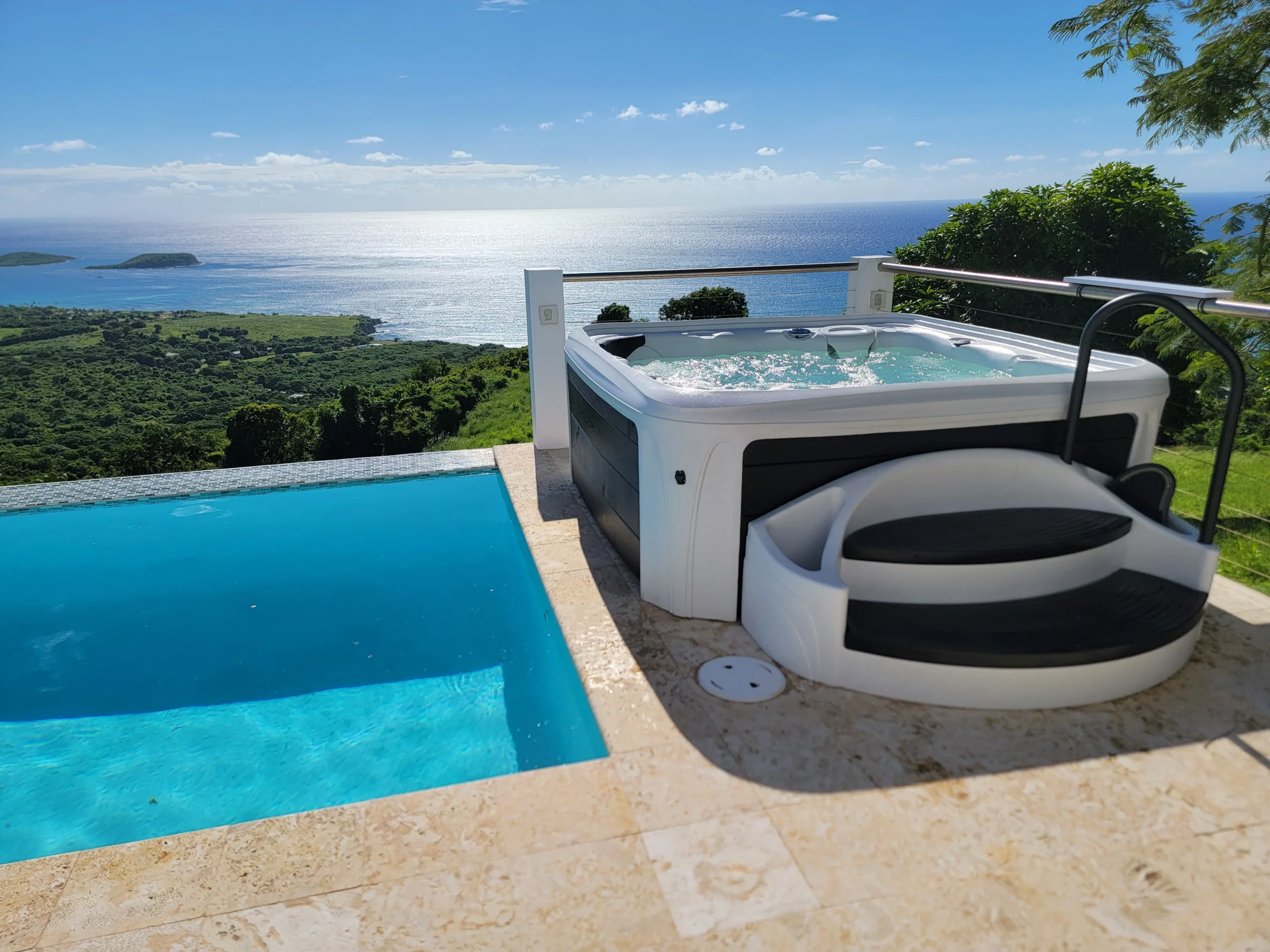 Dream Maker spa installed beside a swimming pool with a view
